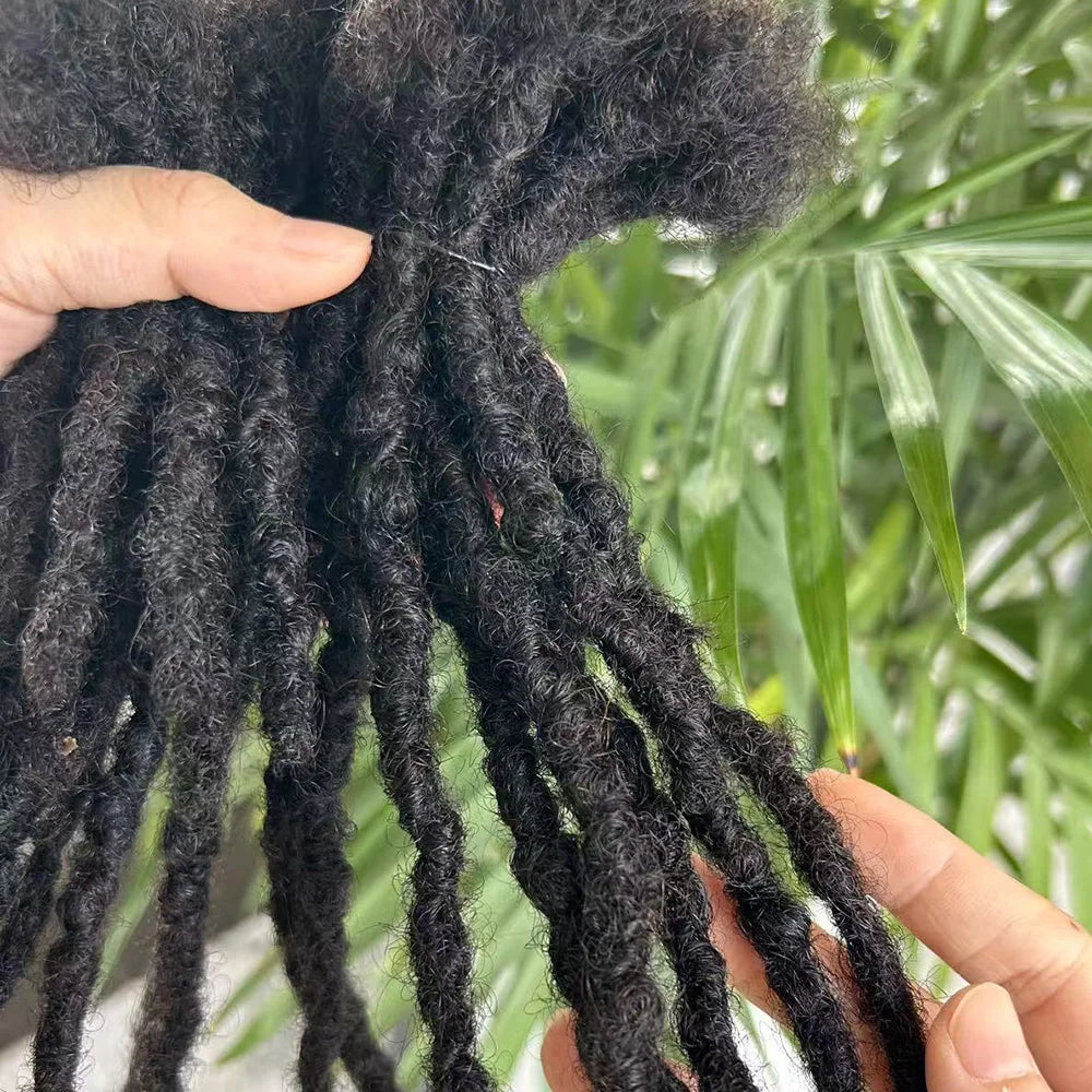 Natural textured human hair dreadlock extensions held in hand for stylish hair transformations
