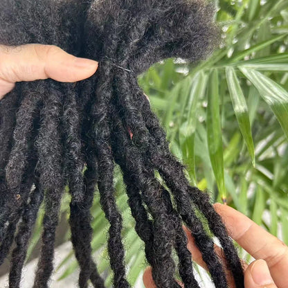 Natural textured human hair dreadlock extensions held in hand for stylish hair transformations