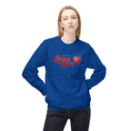 Woman wearing blue Jesus is Love sweatshirt with red heart graphic and casual black pants
