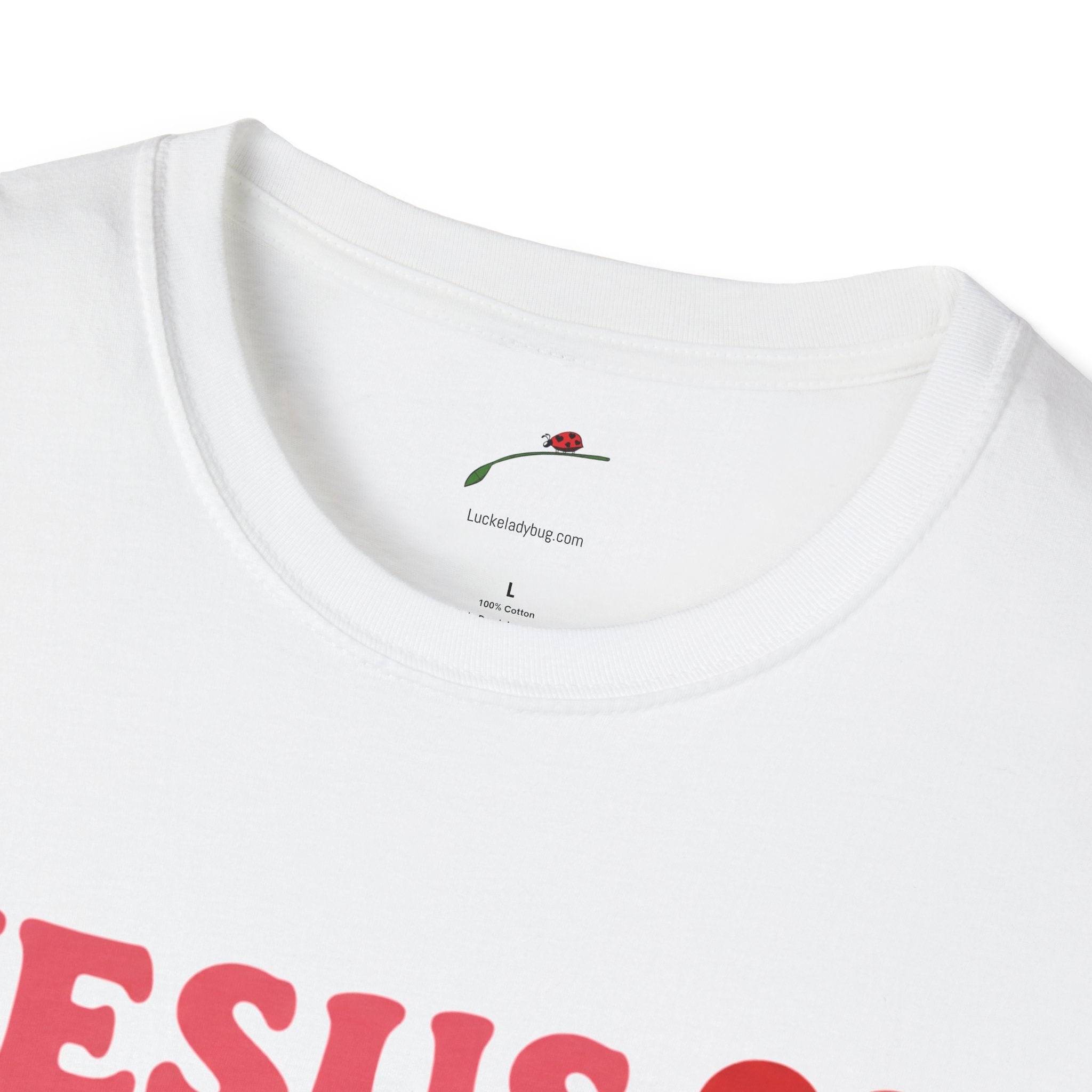 Close-up of Printify white Jesus is Love t-shirt with red lettering and round neckline