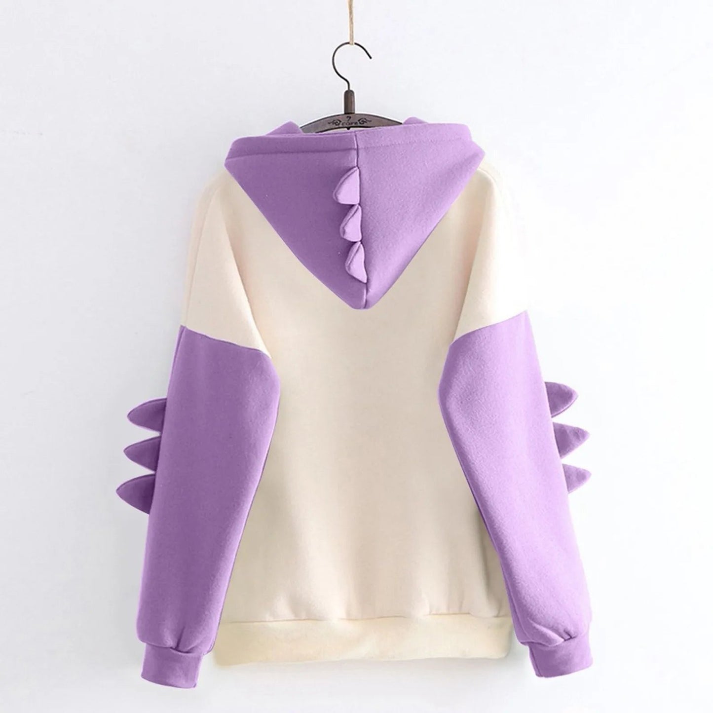 Kawaii dinosaur hoodie for women in cream and purple with spike details on the sleeves