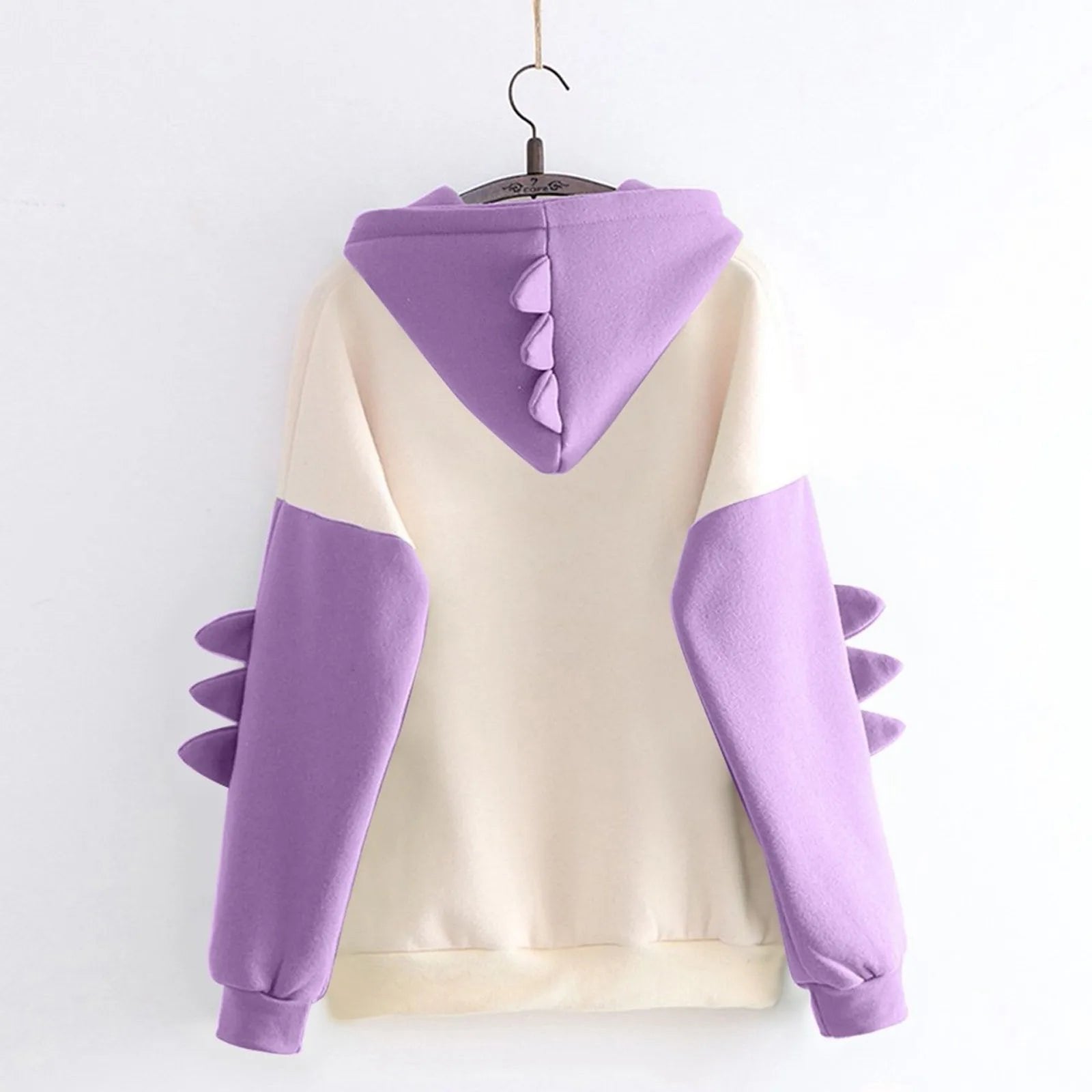 Kawaii dinosaur hoodie for women in cream and purple with spike details on the sleeves