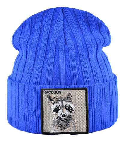 Blue knitted beanie hat with patch featuring a raccoon design by LuckeLadybug LLC