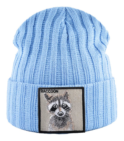 Light blue knitted beanie hat with patch featuring a raccoon design for stylish winter wear