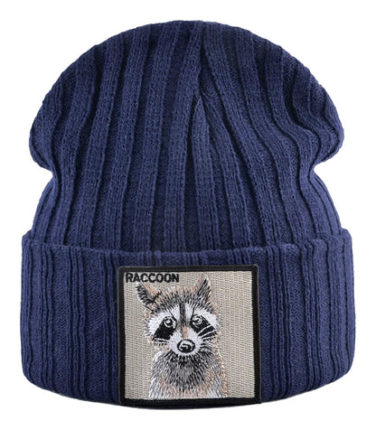 Navy knitted beanie hat with patch featuring a raccoon design, perfect for cold weather wear