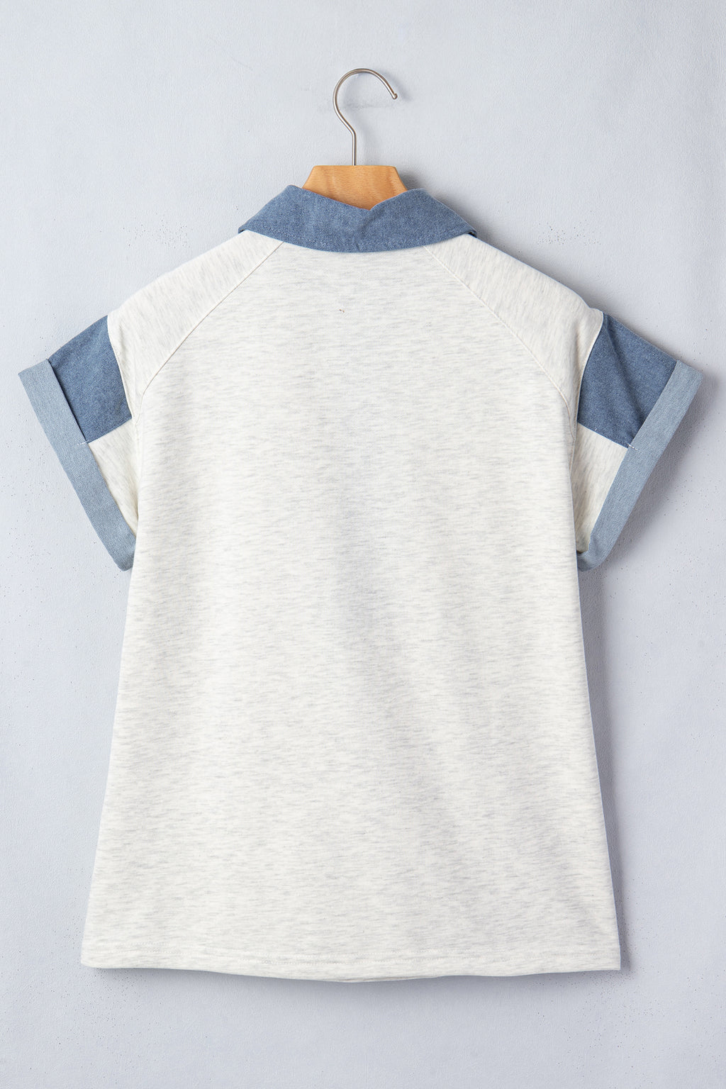 Back view of a ladies denim blouse with short sleeves and a stylish collar design