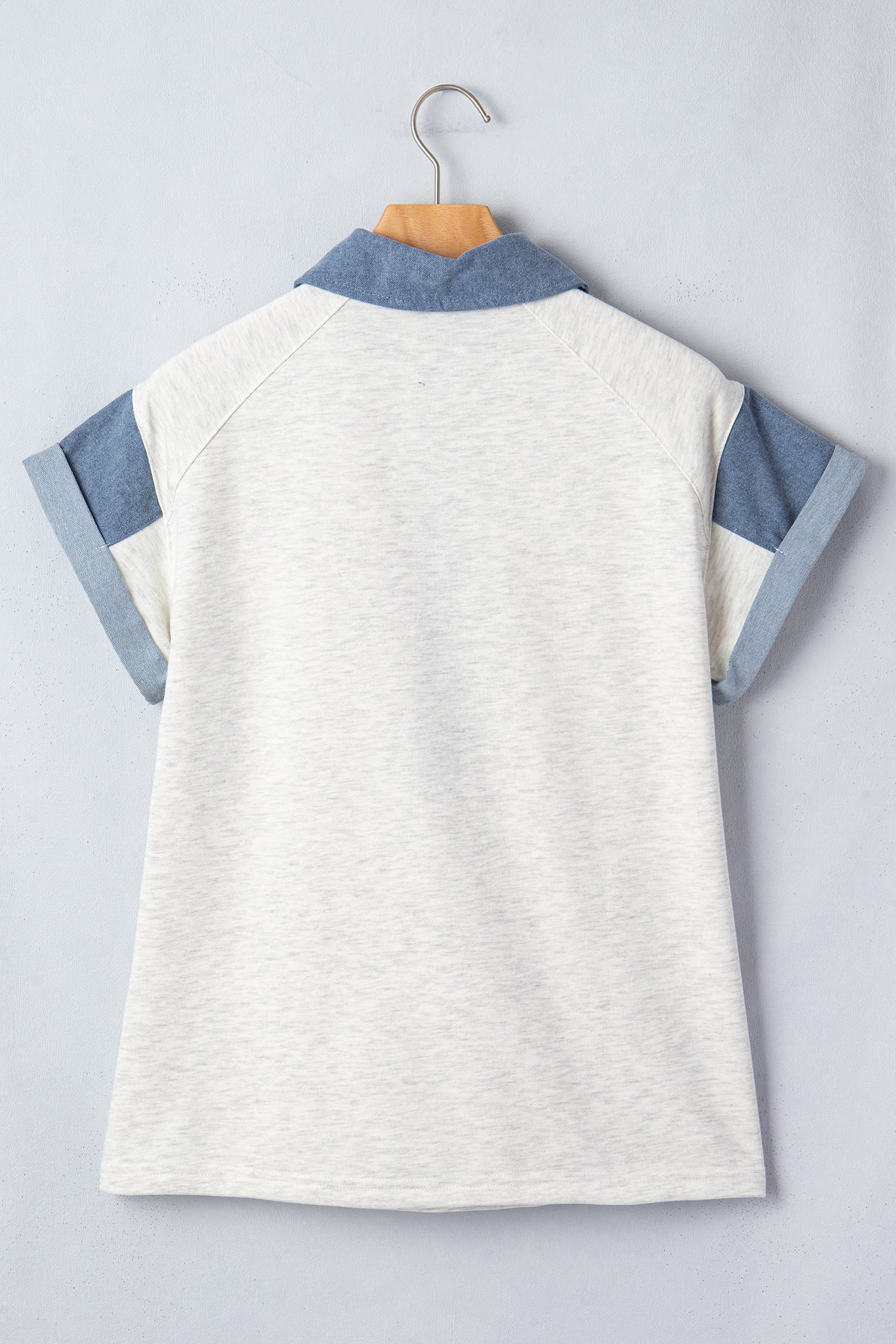 Back view of a ladies denim blouse with short sleeves and a stylish collar design