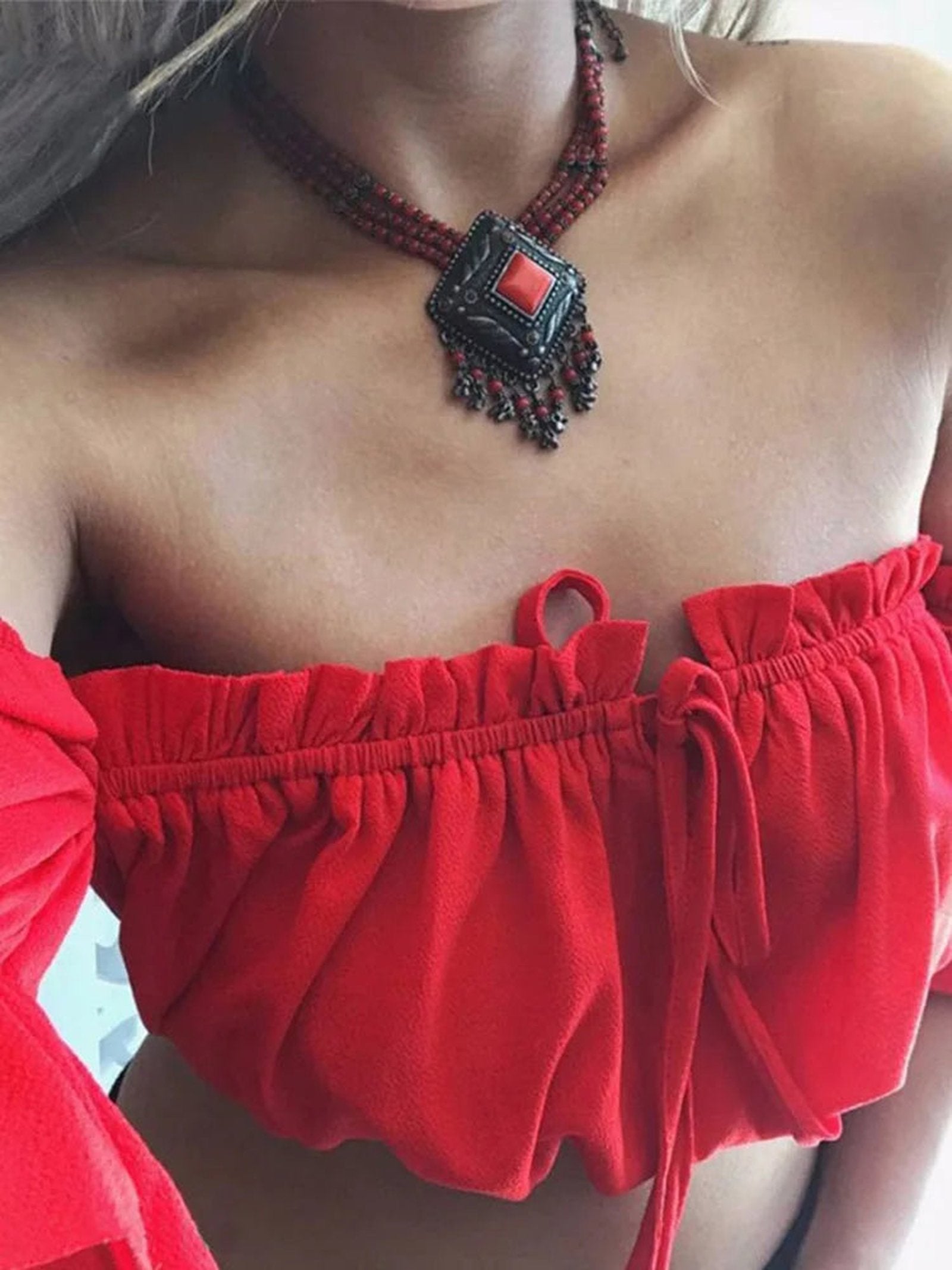 Stylish red lantern sleeve crop top for women with a ruffled design and trendy necklace