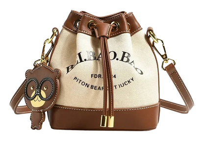Stylish large capacity drawstring bucket bag with bear keychain and leather accents