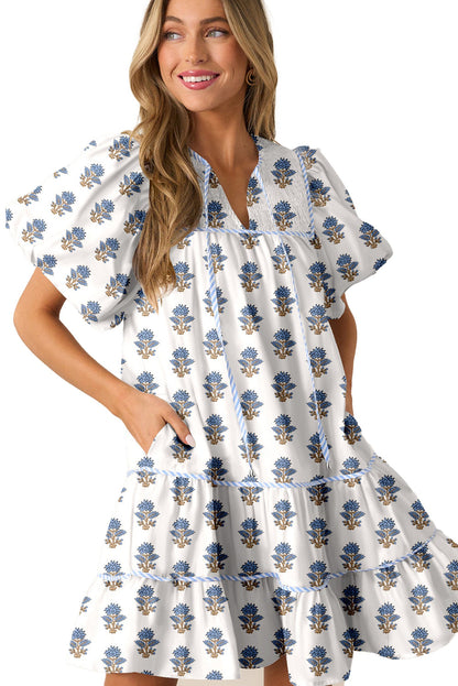 LuckeLadybug sky blue floral mini dress with puff sleeves tiered ruffle skirt and side pockets on model