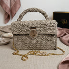 Stylish woven clutch with gold chain, featuring a clasp, perfect for any occasion as a leather crossbody mini bag