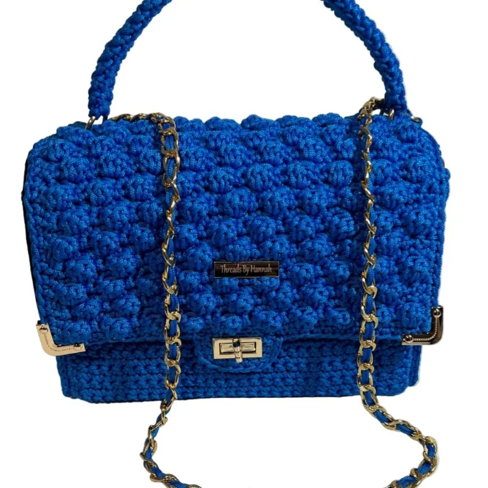 Handmade leather handbag handmade in vibrant blue with a stylish chain strap and textured design