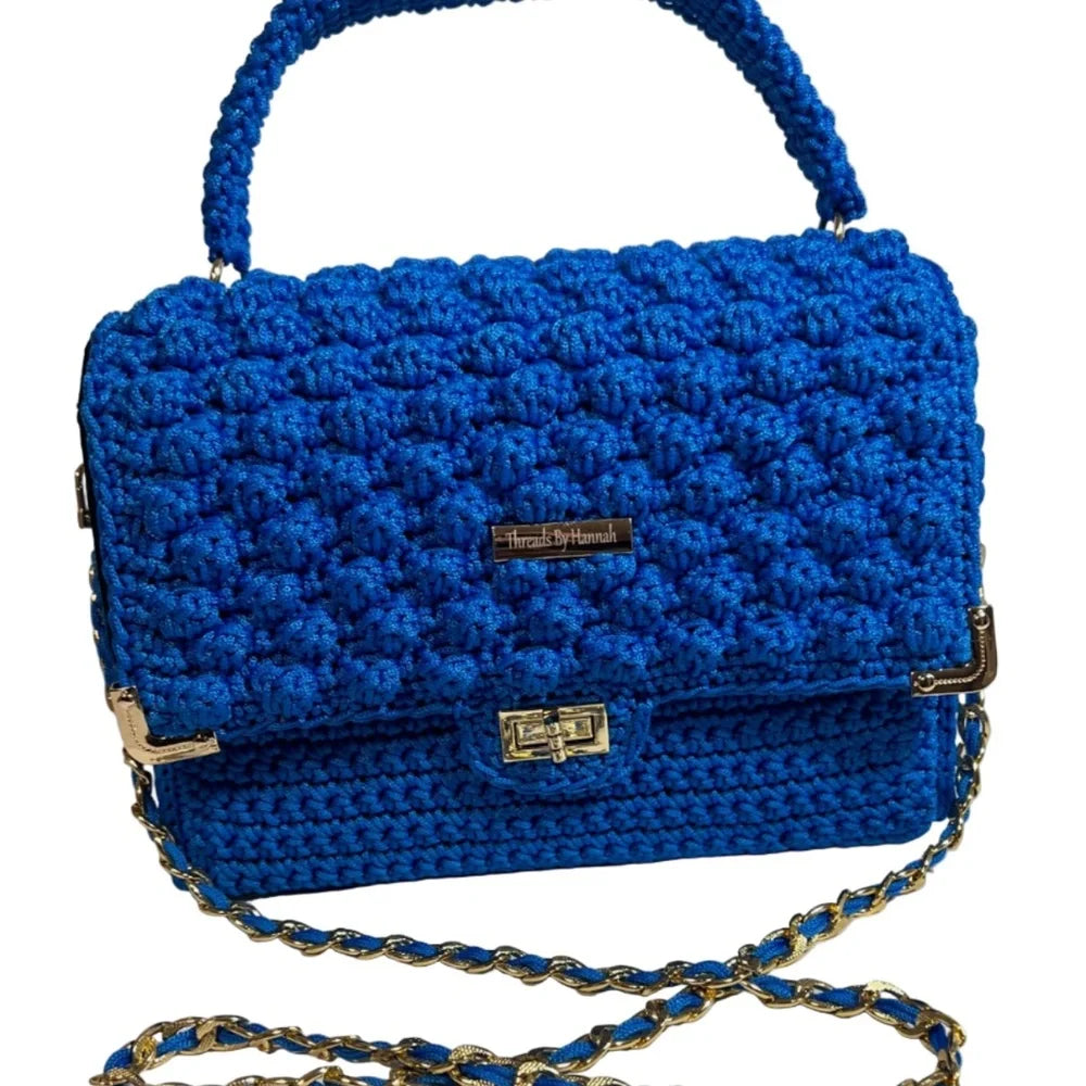 Blue crocheted clutch bag from ThreadsByHannah, a stylish leather handbag handmade with a unique design