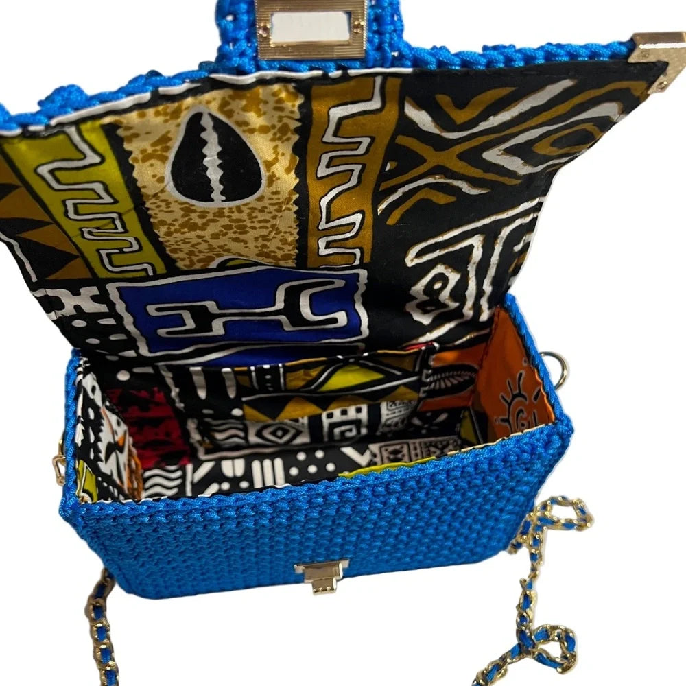 Handmade leather handbag with colorful interior design showcasing intricate patterns
