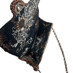 Elegant leather woven purse with floral interior and decorative chain strap for stylish occasions