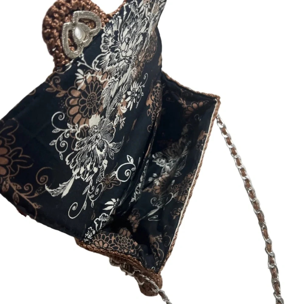 Elegant leather woven purse with floral interior and decorative chain strap for stylish occasions