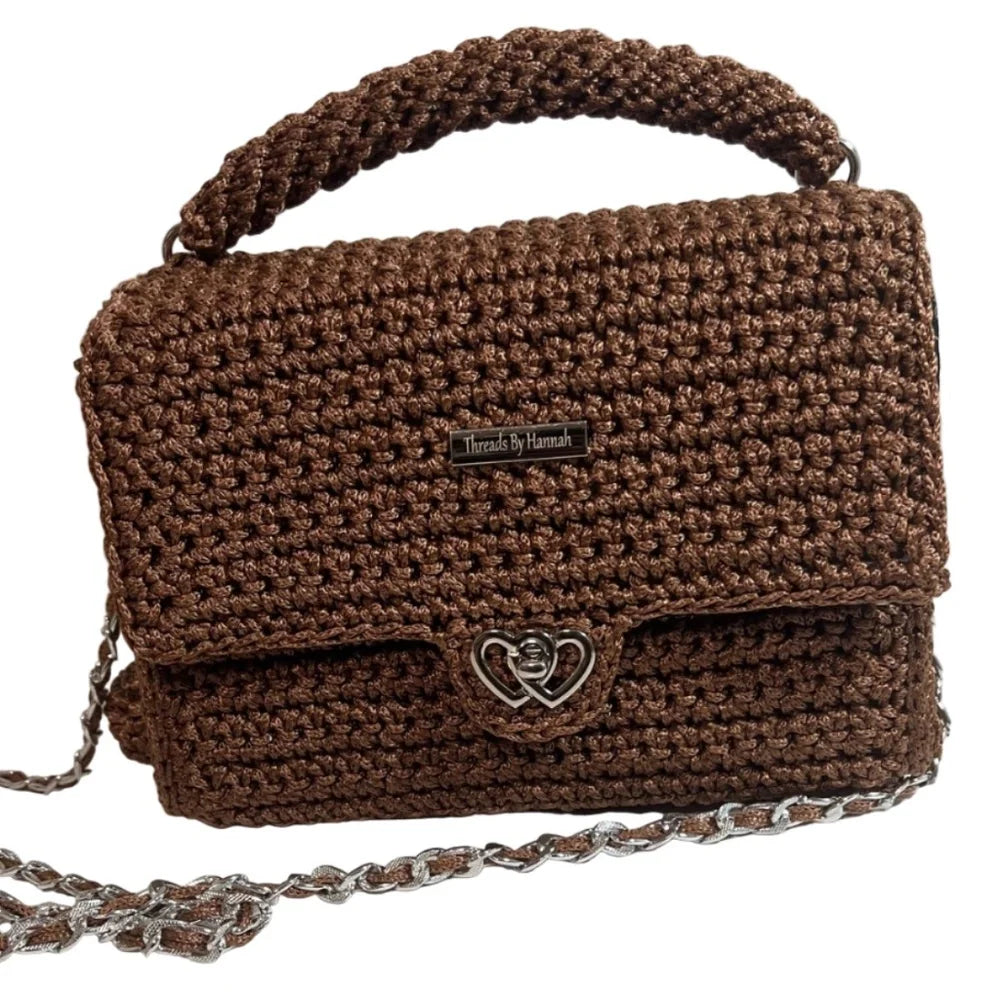 Brown woven clutch purse from ThreadsByHannah featuring a metal heart closure and chain strap