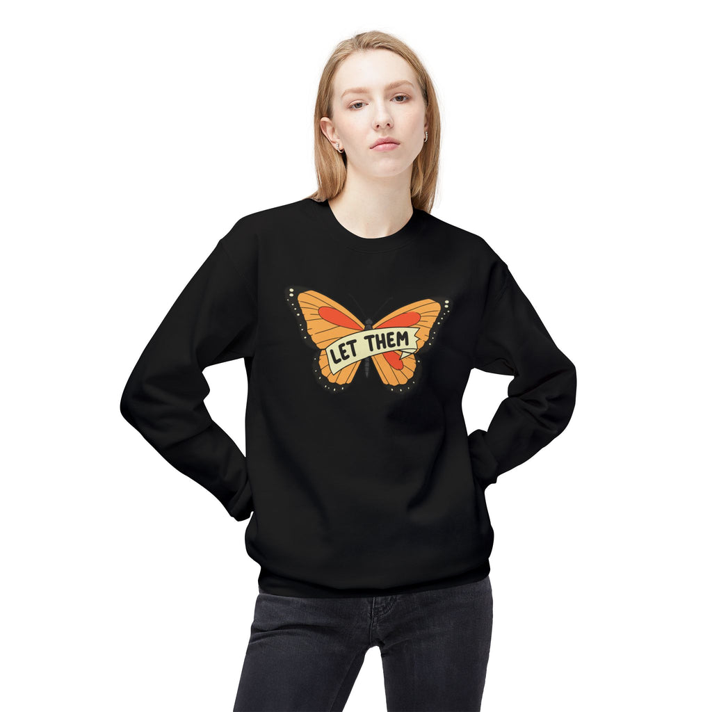 Black let them butterfly sweater with orange butterfly graphic worn by woman posing with hands on hips