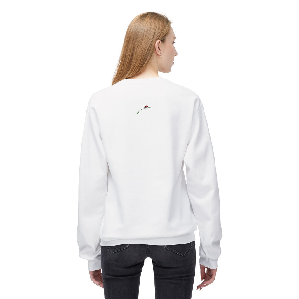 Woman wearing white let them butterfly sweater from LuckeLadybug with small embroidered design on back