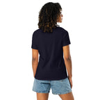 Back view of a woman wearing a plain navy let them words t-shirt for women paired with denim shorts