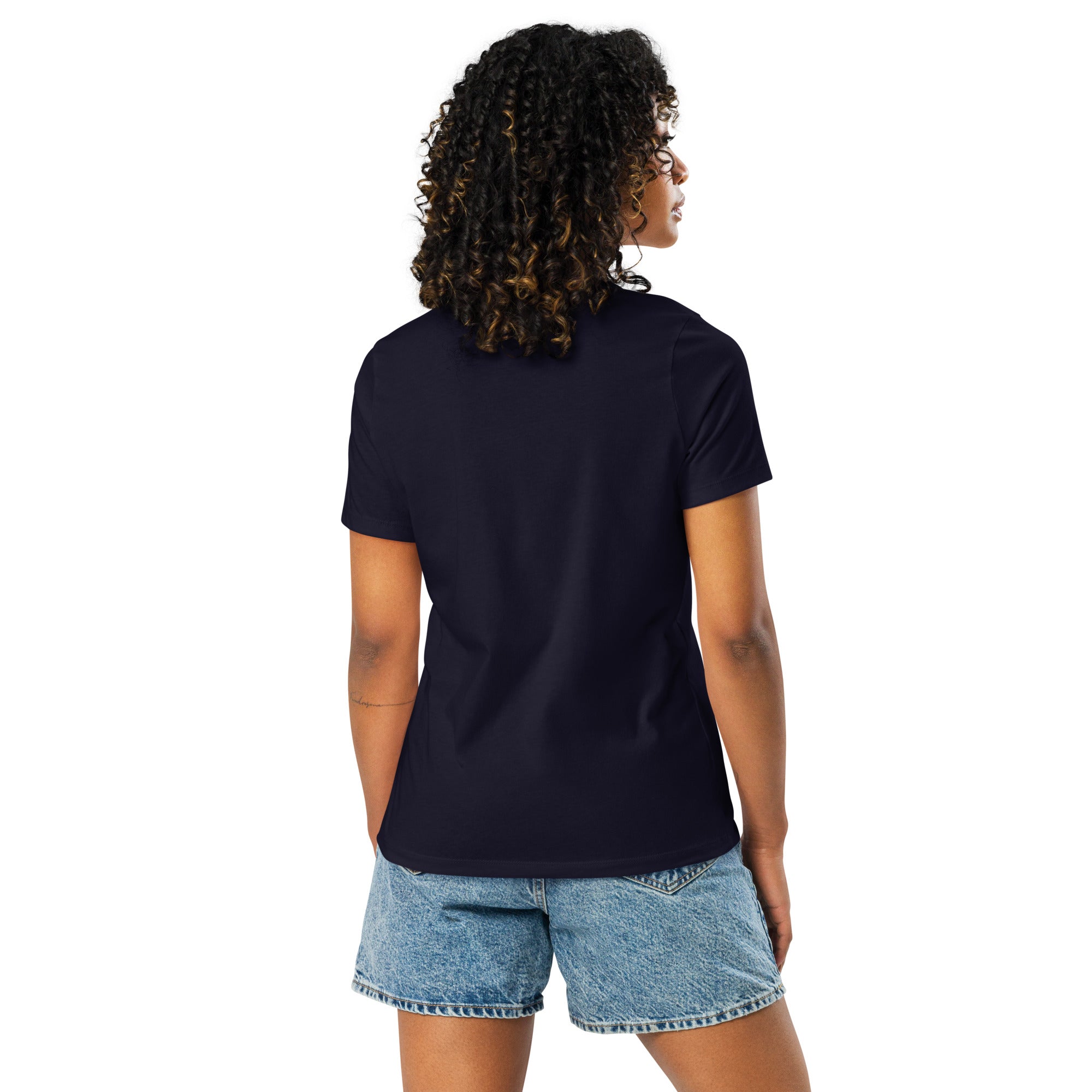 Back view of a woman wearing a plain navy let them words t-shirt for women paired with denim shorts