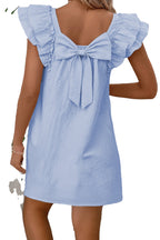 Back view of a light pink flutter sleeve mini dress by LuckeLadybug with a cute bow detail