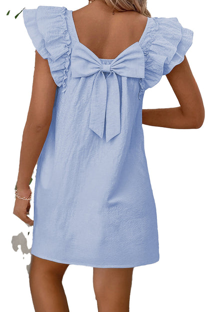 Back view of a light pink flutter sleeve mini dress by LuckeLadybug with a cute bow detail