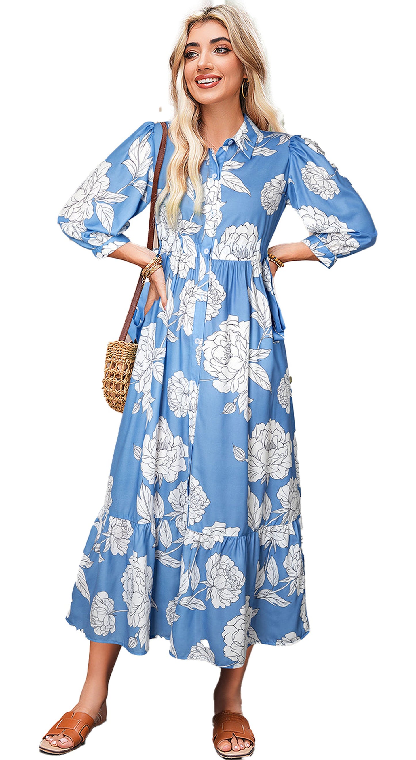Model wearing sky blue floral maxi dress with white large flowers button front 3 quarter sleeves and straw bag