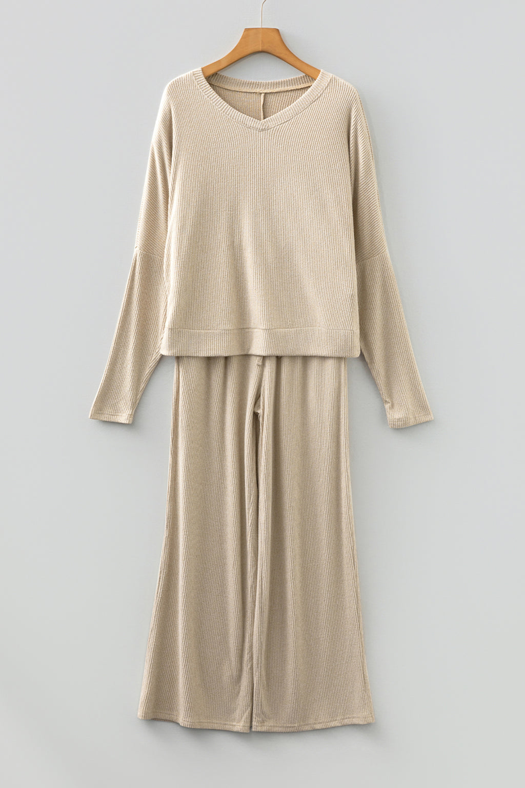 Beige lounge room set featuring a cozy long-sleeve top and wide-leg pants for relaxed comfort