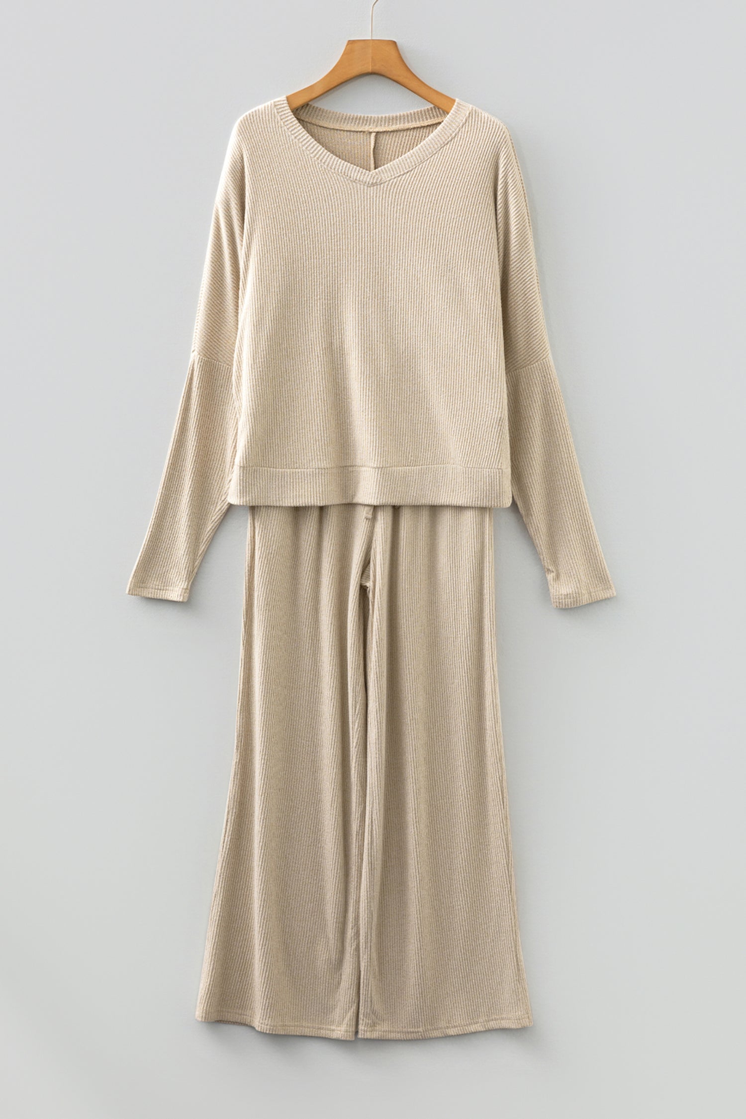 Beige lounge room set featuring a cozy long-sleeve top and wide-leg pants for relaxed comfort