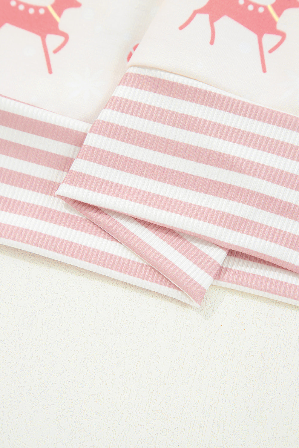 Pink striped pants with festive deer design, perfect for a cozy lounge room set
