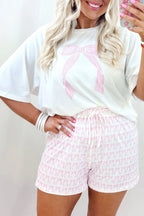 Pink pattern shorts styled with a relaxed white t-shirt for a casual lounge room set look