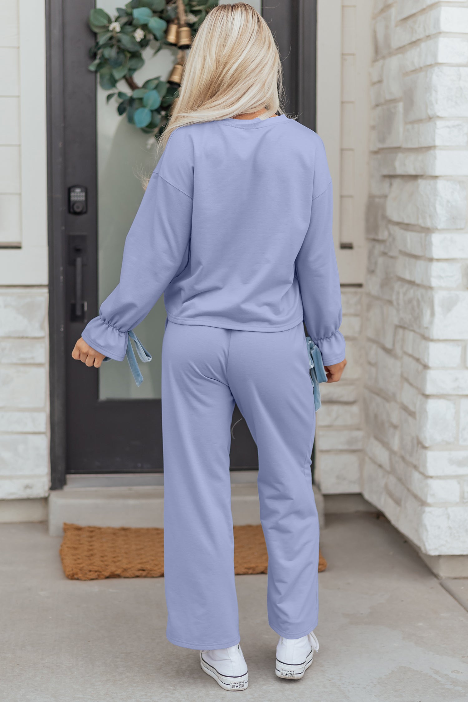 Woman wearing lavender loungewear set with relaxed fit pants and soft pullover from LuckeLadybug LLC