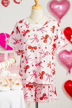 LuckeLadybug loungewear set featuring pink shorts and top with red bow prints for comfortable relaxation