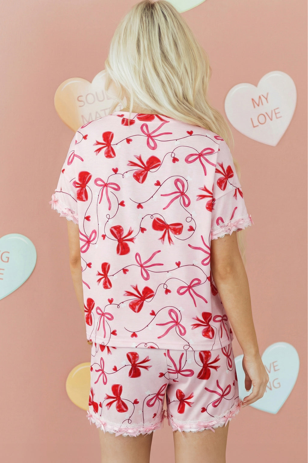 Pink loungewear set from LuckeLadybug LLC featuring a bow print and lace trim for stylish comfort