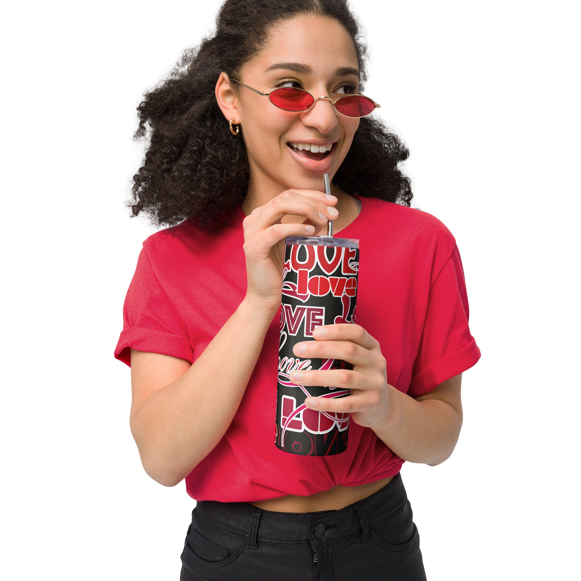Woman holding LuckeLadybug stainless steel love design tumbler with red and black pattern and drinking with a straw