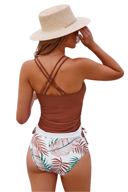 LuckeLadybug 2 piece tankini bathing suit with brown top and tropical print bottoms worn by woman with straw hat