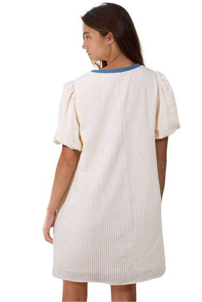 Back view of beige stripe seersucker dress by LuckeLadybug LLC with puff sleeves and relaxed fit