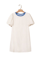 Beige stripe seersucker dress with blue collar and puff sleeves hanging on wooden hanger