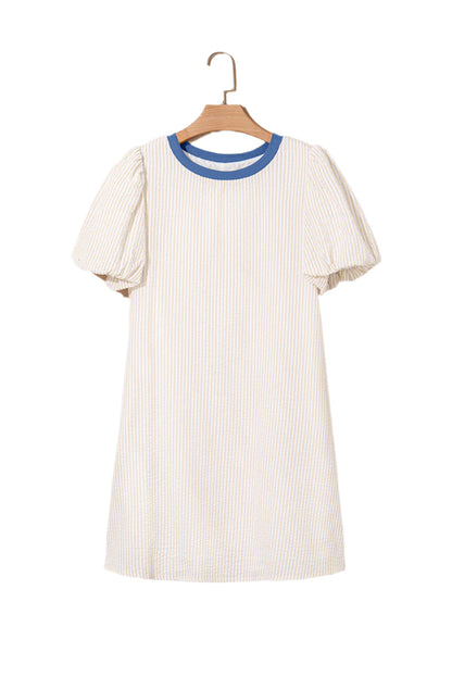 Beige stripe seersucker dress with blue collar and puff sleeves hanging on wooden hanger