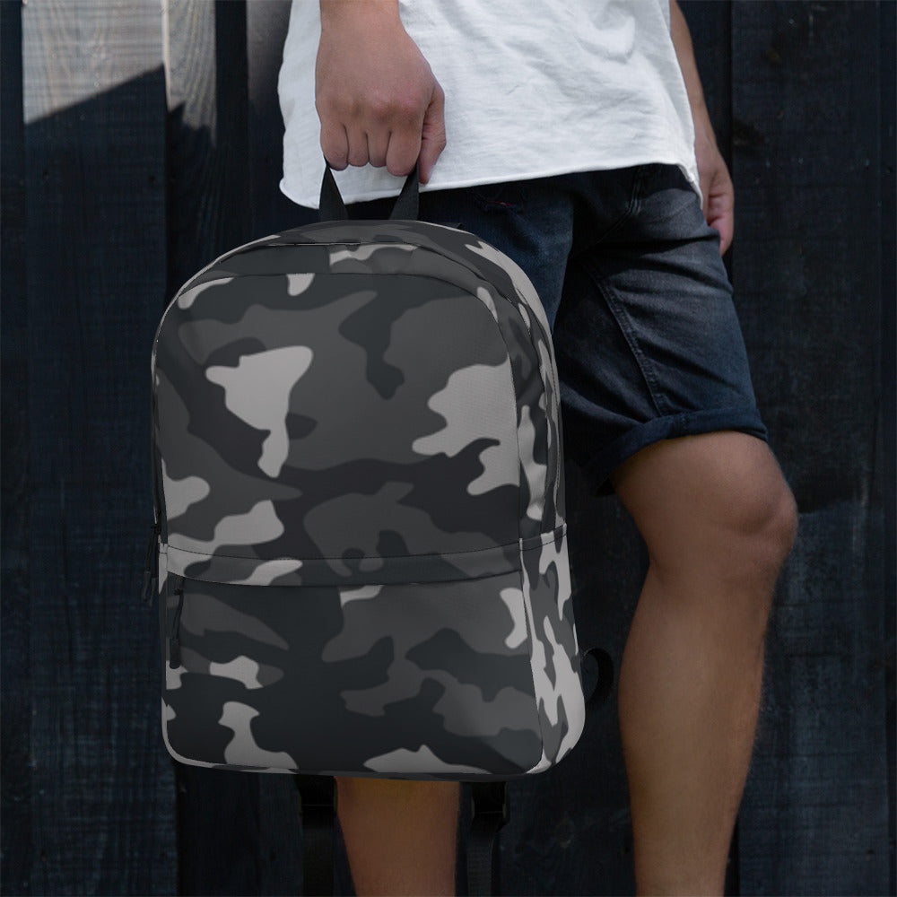 LuckeLadybug Black Camo Design Backpack For Everyday Use. Gray and black camo backpack held by person at side