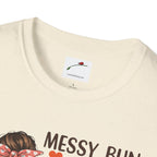 LuckeLadybug coffee mom graphic tee in cream color featuring a messy bun design and soft fabric