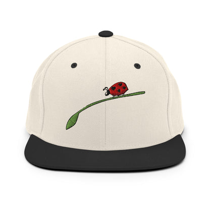 LuckeLadybug fashion snapback for men in beige with black brim featuring embroidered ladybug on green leaf