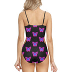 Back view of model wearing neon butterfly one-piece swimsuit black with pink purple butterflies and adjustable straps