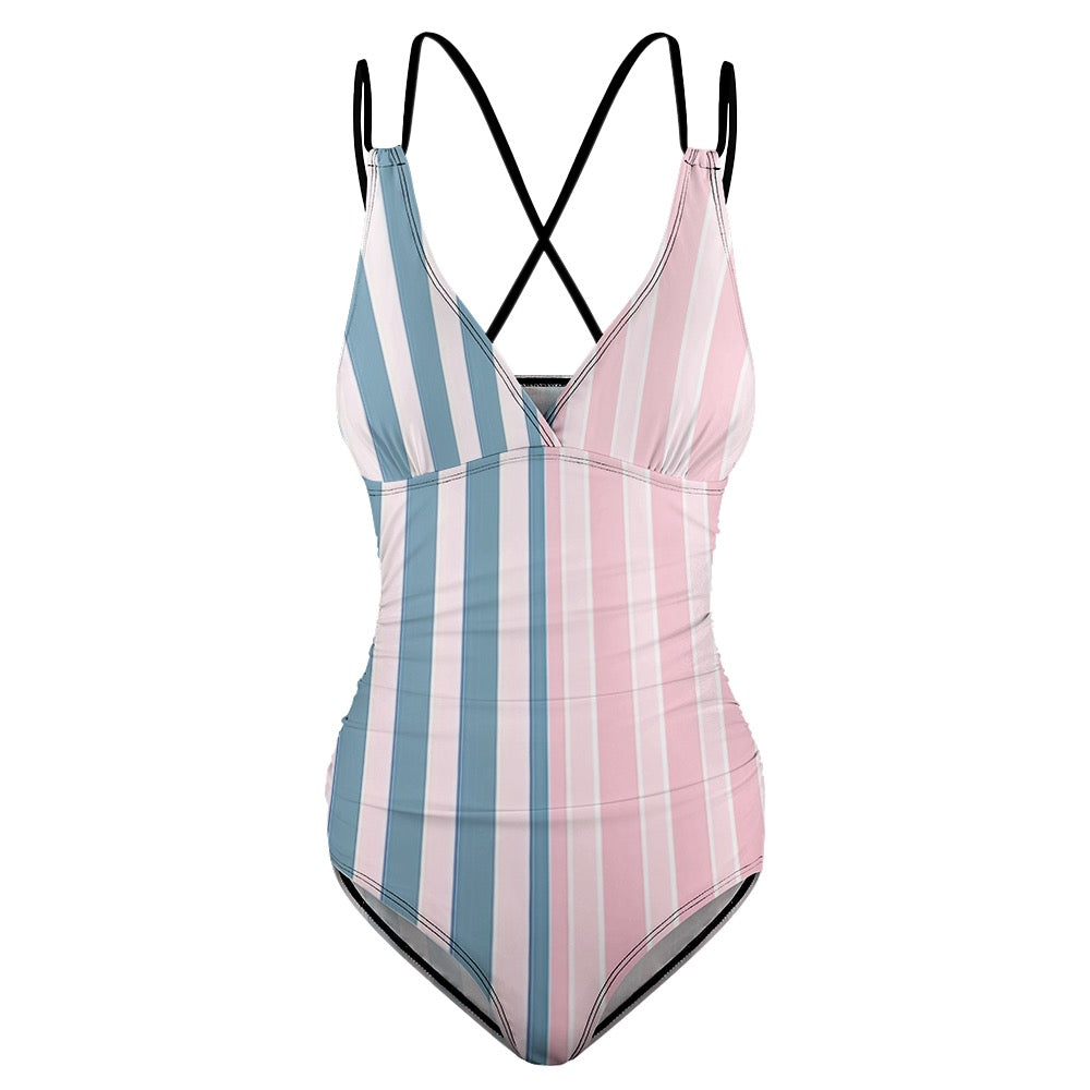 Pink striped one piece swimsuit with blue and white vertical stripes and black crossed straps
