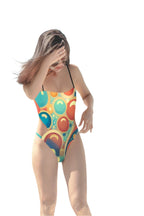  retro cut out swimsuit one-piece with colorful circular pattern on model