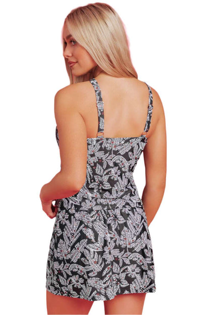Back view of woman wearing LuckeLadybug LLC black and white patterned skirted tankini swimwear set