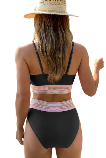 Back view of woman wearing LuckeLadybug LLC striped patchwork swimsuit for women with black and multicolor bands
