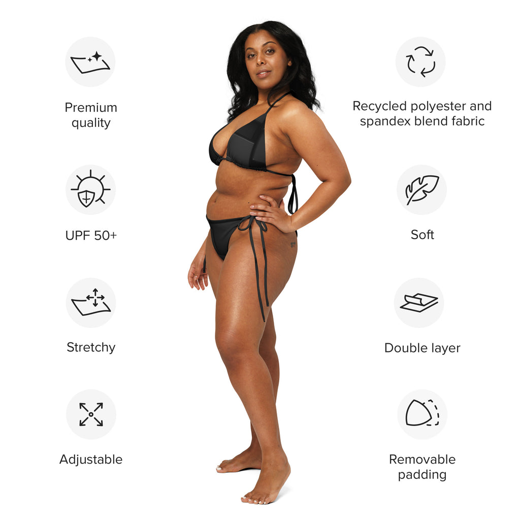 Model wearing sustainable black string bikini made of recycled polyester and spandex blend fabric