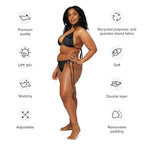 Model wearing sustainable black string bikini made of recycled polyester and spandex blend fabric